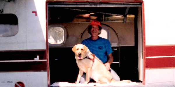 John and Kiowa in the door of an airplane.