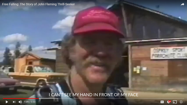 Screen capture of John in the short film Free Falling. It is a moment right after he skydives and he is saying, "I can't see my hand in front of my face."