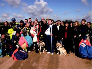 Group photo with John Fleming, Dan Rossi, their guide dogs and friends